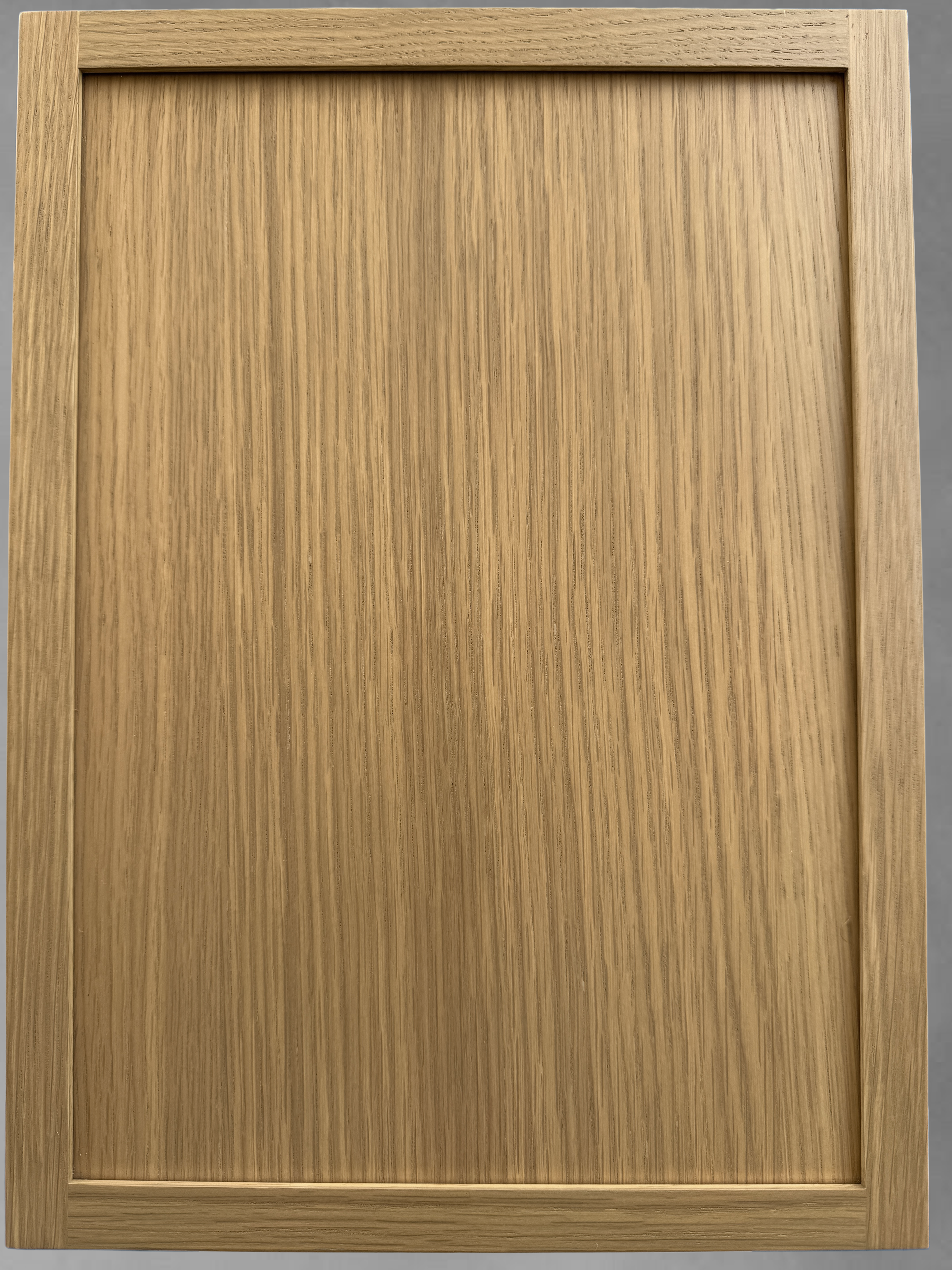 Wooden cabinet door with a beveled edge on a gray background