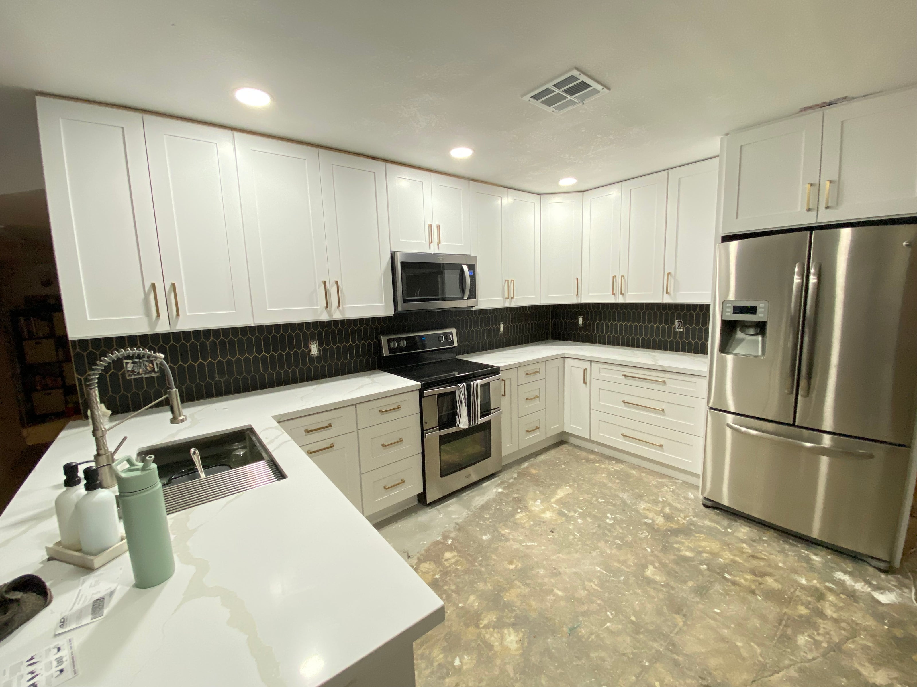 Shaker White Kitchen With Gold Hardware And Black Backsplash