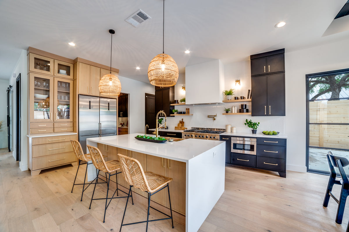 Modern kitchen with white island, wooden cabinets, and stainless steel appliances.