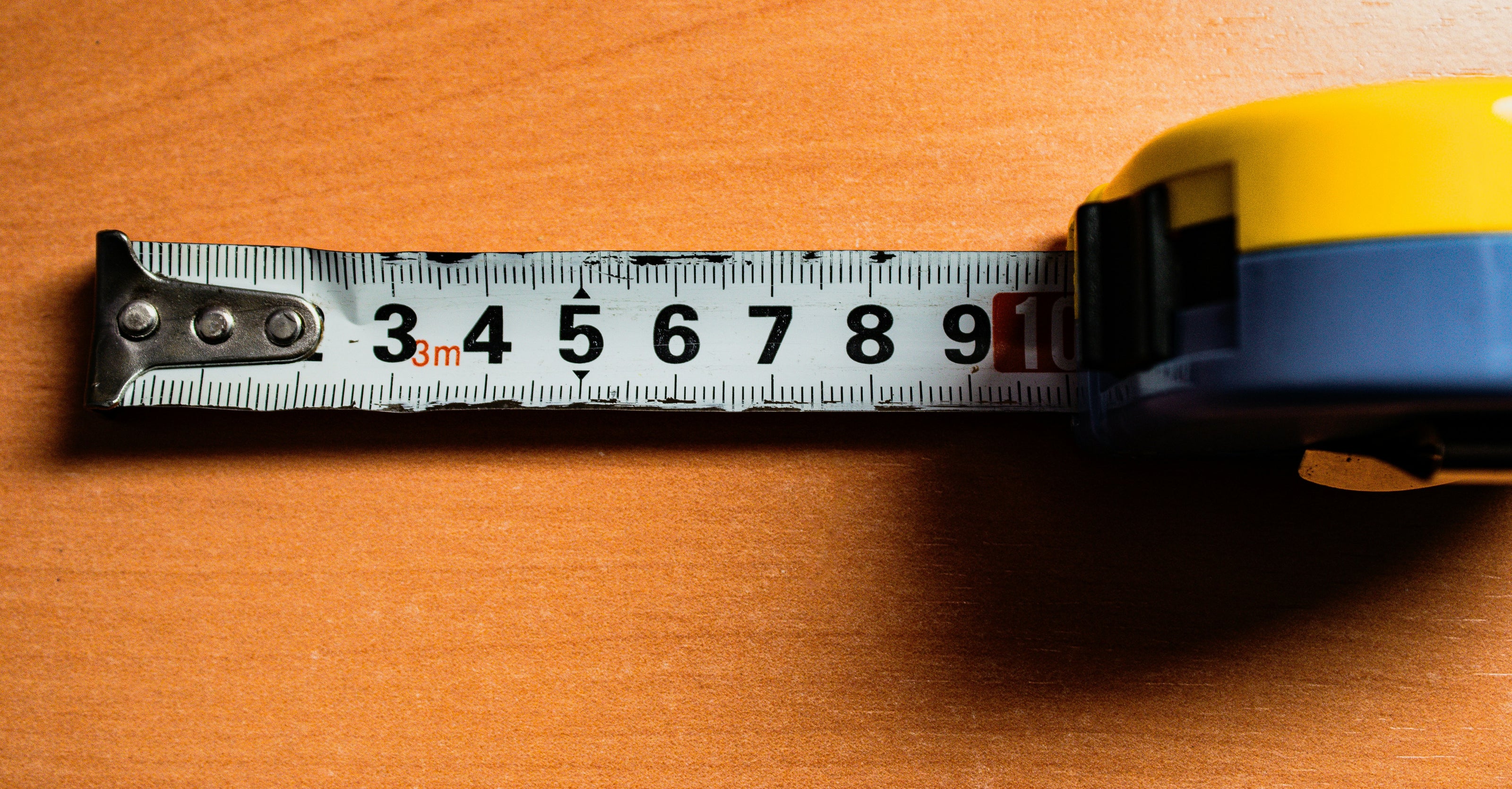 Measuring tape on a wooden surface